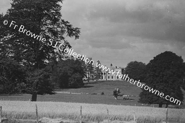 DISTANT VIEW OF HOUSE IN HARVEST TIME